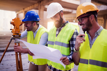 Portrait of construction engineers working on building site