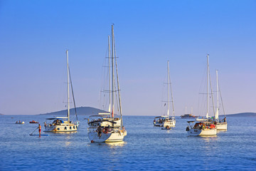 Fototapeta na wymiar Anchored sailing boats in the bay on island Murter, Croatia