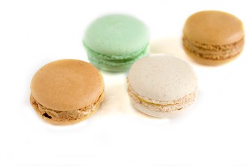 Colorful french macaroons on the blue table close up view