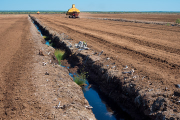 Reclamation system at peat farm. Agricultural technology. Peat extraction machine