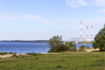 Fototapeta na wymiar The Volga River. Central Russia.Power line and power station on the banks of the river.Background for the site about travel,electricity,power station.