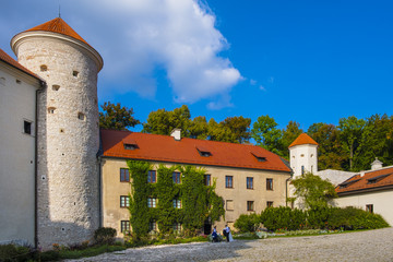 Fototapeta na wymiar Pieskowa Skala, Poland - Inner courtyard and gothic tower of historic castle Pieskowa Skala by the Pradnik river in the Ojcowski National Park