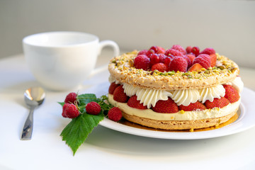 Delicious home made cake with fresh strawberries and rasberries on the white background. Isolated