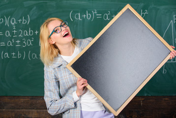 Remember this information. School schedule and information. Hometask information. Teacher show school information. Teacher smart smiling woman hold blackboard blank advertisement copy space
