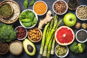 Superfoods on black stone background. 
