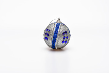 Decoration for Christmas tree - silver ball with blue rhinestones, isolated on white background. Christmas decoration or toy for Christmas tree with silver shimmering surface
