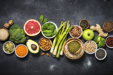 Superfoods on black stone background. 