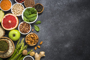 Superfoods on black stone background. 