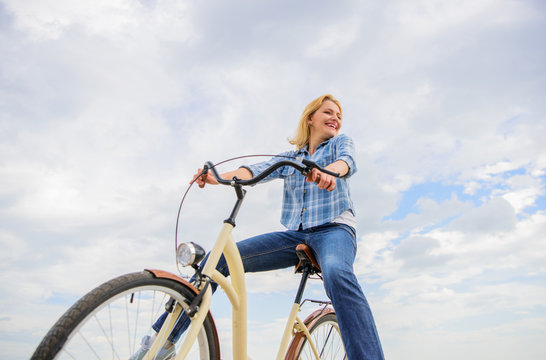 Girl rides bicycle sky background. Most satisfying form of self transportation. Carefree and satisfied. Woman feels free while enjoy cycling. Cycling gives you feeling of freedom and independence