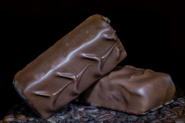 Two chocolate bars on a dark background