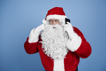 Fototapeta na wymiar Santa claus talking by mobile phone
