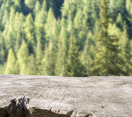 Empty wooden table with blurred mountain outdoor background. Ready for product montage.