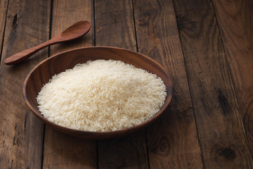 raw rice on wood plate