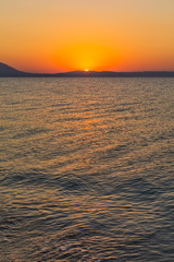Fototapeta premium Early morning , dramatic sunrise over sea and mountain. Photographed in Asprovalta, Greece.