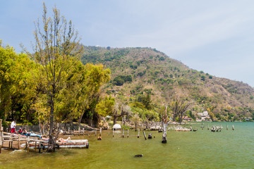 SAN MARCOS LA LAGUNA, GUATEMALA - MARCH 25, 2016: People at the coast of Atitlan lake.