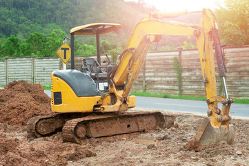 Excavator in sunlight..Digger machine  digging and removing earth adjusting ground level in construction site..