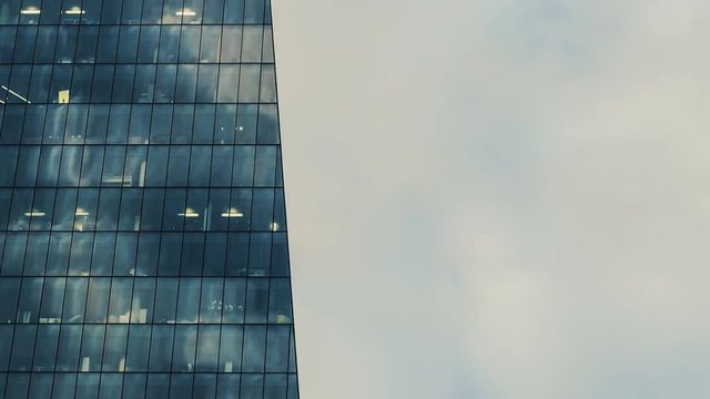Timelapse od modern office building at evening sunset sun with beautiful clouds moving in the backround, work late concept