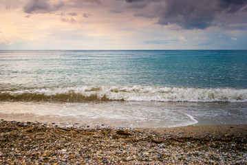 The sea shore, with blue sky and clouds and clear sea