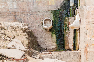 View of a Ghat (riverfront steps) with urinals, in Varanasi, India