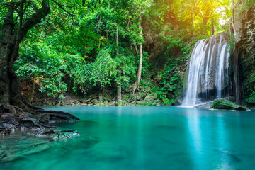 Fototapeta na wymiar Erawan waterfall in tropical forest of national park, Thailand 