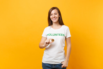 Woman in white t-shirt with written inscription green title volunteer hold bitcoin, metal coin...