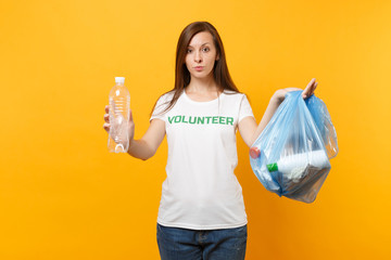 Woman in t-shirt volunteer, trash bag isolated on yellow background. Voluntary free assistance help, charity grace. Environmental pollution problem. Stop nature garbage environment protection concept.