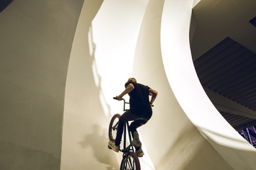 Guy riding a bmx bike on the street. Freestyle BMX in the city