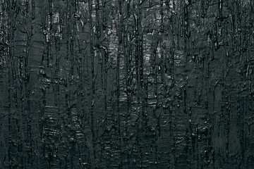 Wall with black flowing paint, art background
