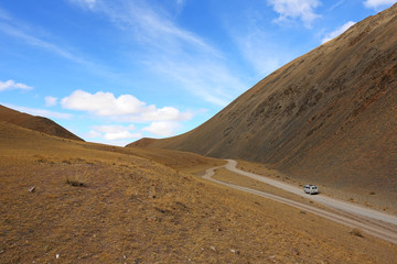Fototapeta na wymiar Path of car on rural roads in the desert mountain of the Western Mongolia