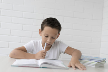 schoolboy doing homework studying science studyin, isolated on white background