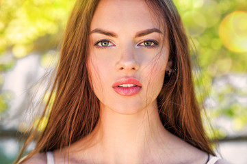 Portrait of a young woman outdoors.