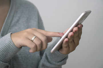 Woman hand holding smartphone. She using application on mobile phone.