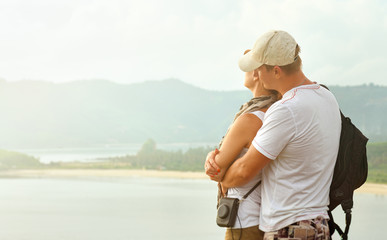 Happy lovely couple resting near ocean