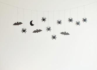 Decorations for Halloween party, black paper garland with moon, spiders and bats.