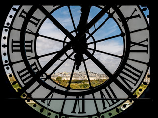Naklejka premium Paris cityscape through the giant clock at the Musee d'Orsay with view on the Seine river, Tuileries Garden, Palais royal, Opera Garnier, Sacre-Coeur and Montmartre hill - Paris, France