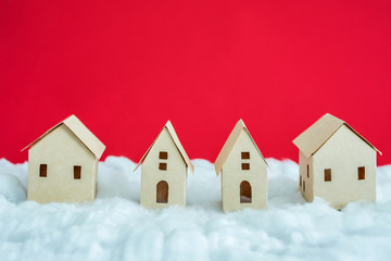 paper houses, white snow, red background with copy space, for advertising, close up