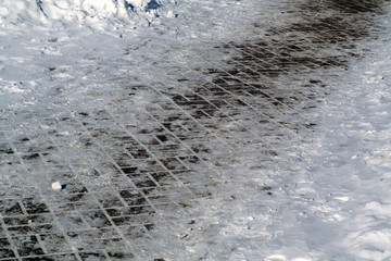 Pavement and snow on its side.