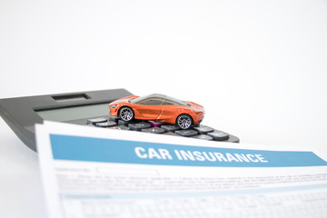 Car insurance concept with car insurense form, toy car and calculator