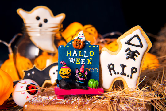 Fresh homemade decorated halloween cookies on dark background with copy space, top view