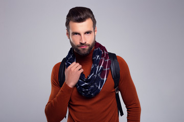  His casual look. Handsome young man in scarf looking at camera while standing against white background