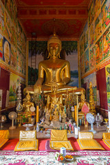 Obraz premium Altar and many golden Buddha statues inside of decorative Wat Mixai (Mixay) (