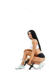 Fitness woman athlete and bodybuilder holding dumbbell . Isolated on white background.