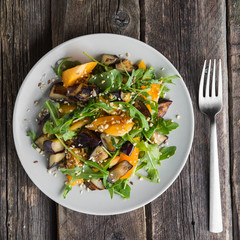 Warm salad with fried eggplant, arugula, cherry tomatoes,