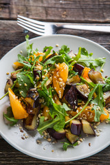 Warm salad with fried eggplant, arugula, cherry tomatoes,