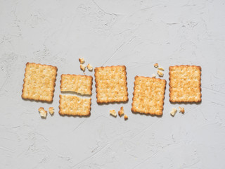 French cracker with sesame seeds on light grey background. Flat lay, top view, copy space