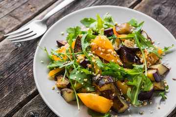 Warm salad with fried eggplant, arugula, cherry tomatoes,