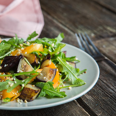 Warm salad with fried eggplant, arugula, cherry tomatoes,