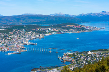 View of Tromso on island of Tromsoya linked across Tromsoysundet strait with Tromsdalen on mainland by a Tromso Bridge. Norway