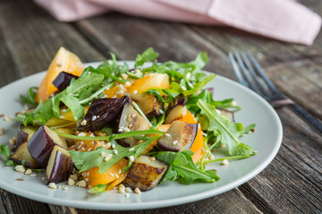 Warm salad with fried eggplant, arugula, cherry tomatoes,