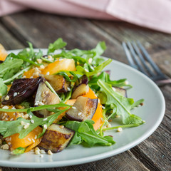 Warm salad with fried eggplant, arugula, cherry tomatoes,